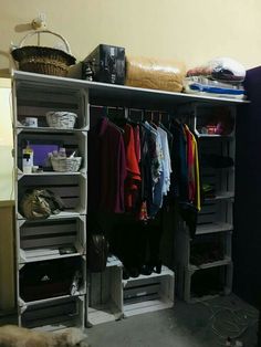 the closet is full of clothes and other things to put in it's bins