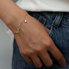 This Arabic Love Bracelet features the word for 'love' in Arabic which translates to Hubb. It features a dainty gold chain with high quality square cubic zirconia crystals. This bracelet is the perfect matching piece to our best selling Arabic Love Necklace. We make our jewellery in small batches to reduce wastage. Our jewellery is designed with the modern Woman in mind, elegant, unique pieces with a classic touch. Our jewellery is great for gifting, whether it's Valentines, Mothers Day, Birthda Love In Arabic, Bracelets Minimalist, خواتم خطوبة, Dainty Gold Chain, Bracelet Layering, Arabic Jewelry, Dainty Gold Jewelry, Dainty Gold Bracelet, Gold Jewelry Gift