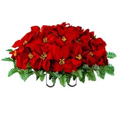 a bunch of red poinsettia in a metal holder