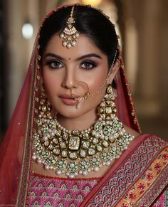 a woman wearing a bridal outfit and jewelry