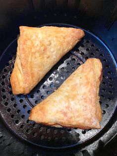 two pastries sitting on top of a frying pan in an air fryer