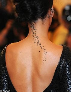 the back of a woman's neck with stars on it