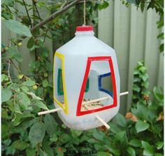 a bird feeder hanging from a tree outside