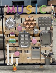 a display made out of wooden pallets with various items on it and the word music spelled in large letters