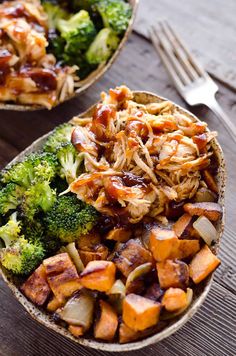 two bowls filled with food sitting on top of a wooden table