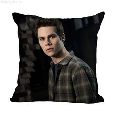 a pillow with the image of a young man wearing a plaid shirt and looking at the camera