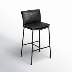 a black leather bar stool sitting on top of a white floor