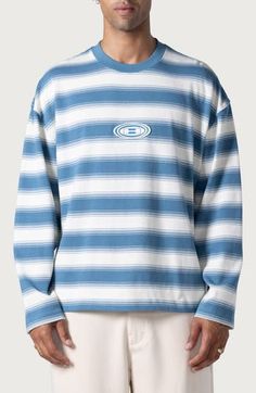 Retro stripes add bold style to a soft, oversized cotton-jersey T-shirt sporting a logo appliqué front and center. 27" length (size Medium) Crewneck Long sleeves 100% cotton Machine wash, tumble dry Imported Black Owned/Founded Blue Drop Shoulder Tops For Spring, Casual Blue Drop Shoulder Tops, Oversized Crew T-shirt For Spring, Casual Drop Shoulder Tops For College, Sporty Blue Drop Shoulder Tops, Oversized Blue Tops For College, Blue Drop Shoulder Sporty Top, Oversized Crew Neck Graphic Tee, Oversized Blue Retro T-shirt