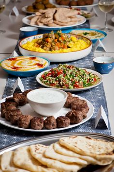 a table topped with plates and bowls filled with food