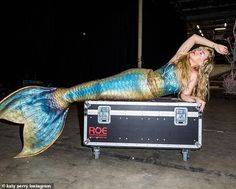 a beautiful woman laying on top of a trunk