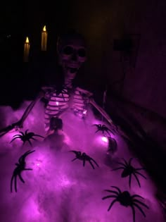 a skeleton sitting in the snow with purple lights