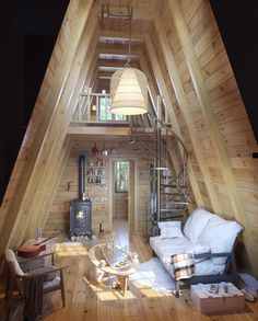 a living room filled with furniture and a spiral staircase leading up to the top floor