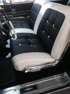 the interior of a classic car with black and white leather