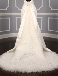 a white wedding dress on display in a room