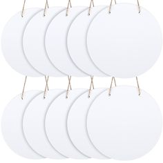 six white round paper tags with wooden handles