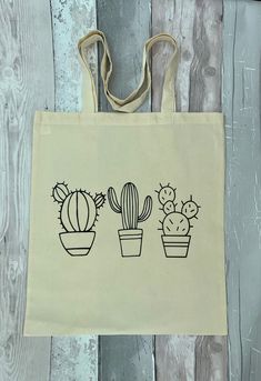 a tote bag with three cacti on it