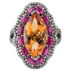 An epitome of opulence and sophistication, the 11.34 Carat Diamond, Golden Topaz, and Ruby Cocktail Ring is a true marvel of jewelry design. At its core, an extraordinary golden topaz captivates with its rich, amber hue and impeccable clarity. Weighing 11.34 carats, this stunning gemstone is masterfully faceted to reflect light with mesmerizing brilliance, exuding a warm, radiant glow. Surrounding the golden topaz are vibrant rubies, meticulously placed to create a striking contrast. Each ruby i Luxury Multi-stone Yellow Gemstones, Luxury Yellow Multi-stone Gemstones, Luxury Platinum Ruby Ring, Luxury Multi-stone Yellow Diamond Ring, Luxury Marquise Ruby Ring With Diamonds, Luxury Marquise Ruby Ring, Luxury Ruby Gemstone Ring In Platinum, Luxury Yellow Sapphire Multi-stone Ring, Luxury Diamond Cut Gemstones For Formal Occasions