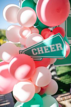 balloons are attached to a sign that says cheer