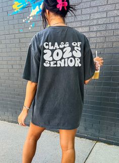 Class of 2025 Senior Tshirt Welcome to our shop! Please note the models shown in the pictures are wearing 1 or 2 sizes up, if this is your desired look, please keep sizing in mind.  All styles shown feature Comfort Colors C1717 an ultra-soft pigment dyed shirt featuring a comfy relaxed feel with 100% Cotton. Other details   .: 100% ring-spun cotton .: Heavy fabric (6.1 oz/yd² (206.8 g/m .: Relaxed fit .: Sewn-in twill label If you need any helping placing an order, please message me and I will b Senior Shirts Ideas High School, Senior Band Shirts, 23niors Shirt, Senior Custom Shirts, Black Summer Tops With School Spirit Style, Black Summer Tops With School Spirit, Senior Tshirts 2025, Graduation T-shirt With Letter Print In Relaxed Fit, Graphic Tee T-shirt For College Events