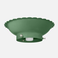 a green ceiling light with scalloped details on the top and bottom, against a white background