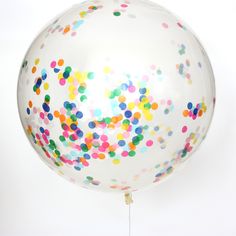 a large white balloon filled with multicolored confetti