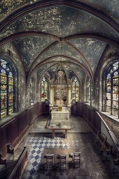 an old church with stained glass windows and pews in the center, is shown