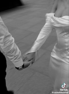 black and white photograph of two people holding hands