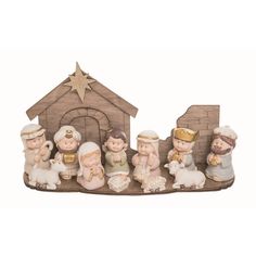 a group of figurines sitting on top of a wooden structure with a nativity scene in the background