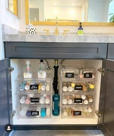 an open cabinet in the middle of a bathroom with soaps, lotions and other items