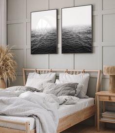 two pictures hanging on the wall above a bed