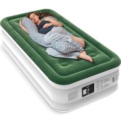 a woman laying on top of an inflatable mattress