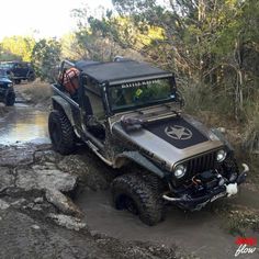 an off road jeep driving through some mud