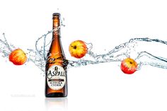 an apple cider with water splashing around it