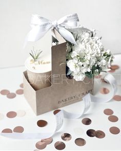 a small box with flowers in it sitting on a table