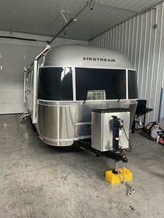 an airstream is parked in a garage