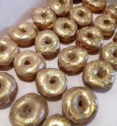 there are many doughnuts that have been placed on the table for display or to be eaten