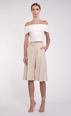 In the Lex Culotte, you'll find the perfect mix of comfort and style. These pleated shorts feature a relaxed fit, high-rise waist, and knee-length hemline. Versatile enough to be dressed up or down with a button down or tee, these culottes make a statement wherever you go. Products Display, Jumpsuit And Blazer, Pleated Shorts, Touch Of Class, Sweater Sale, Romper Dress, Active Wear Tops, Knitting Designs, Skirt Top