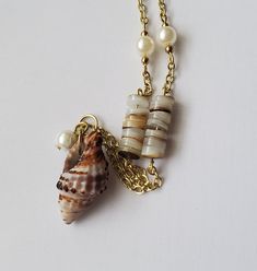 Dainty natural sea shell with a pearl charm. I added saucer shaped natural shell beads and a small pearl accent to tie this necklace together. I can adjust the necklace length upon request. Beach Shell With Pearl Pendant, Beach Shell Necklace With Pearl Pendant, Pearl Beach, Beach Necklace, Seashell Jewelry, Beach Necklaces, Gemstone Beads Jewelry, Seashell Necklace, Chain Extenders