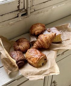 some croissants and other pastries are on the counter