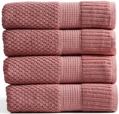 three pink towels stacked on top of each other