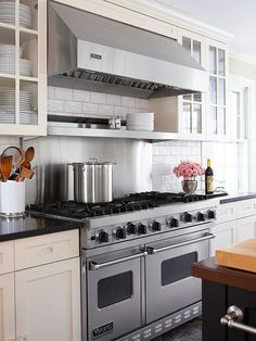 an image of a kitchen setting with pots and pans on the stove top oven