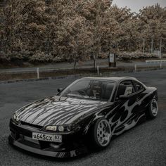 a black and white car with flames painted on it