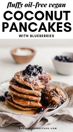 a stack of pancakes with blueberries on top and the title overlay reads fluffy oil - free vegan coconut pancakes with blueberries