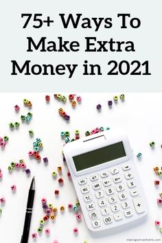 a calculator and pen sitting on top of a table next to some beads