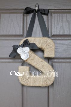 a door hanger with the letter z on it and a ribbon tied around it