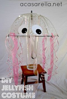 a plastic jellyfish costume with pink streamers and eyes