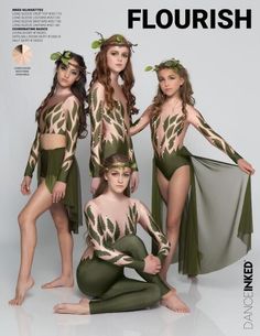 four beautiful women in matching outfits posing for the camera