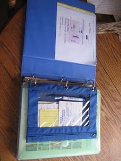 an open binder sitting on top of a wooden table