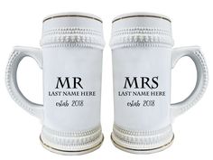 two white mugs with the words mr and mrs engraved on them, sitting next to each other