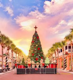 a large christmas tree in the middle of a shopping center with lots of presents on it